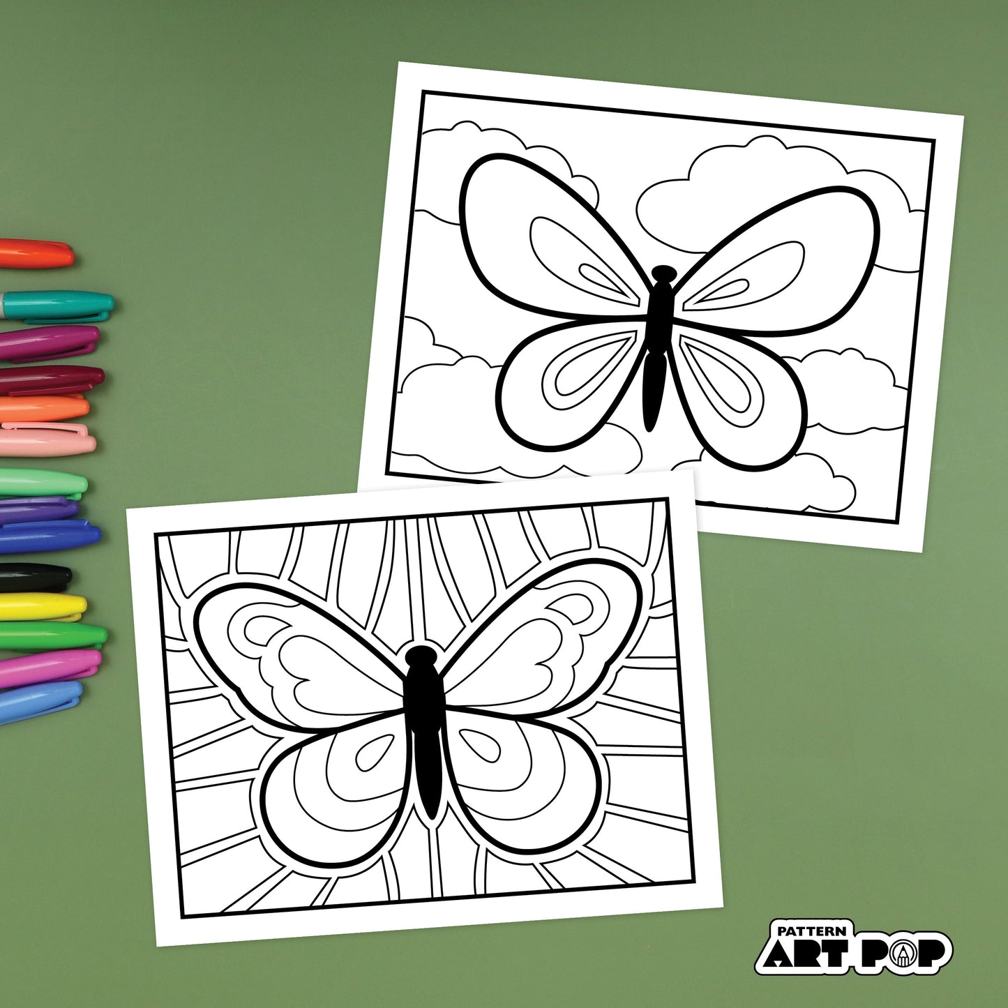 Two butterfly patterning pages with colored markers on a green background