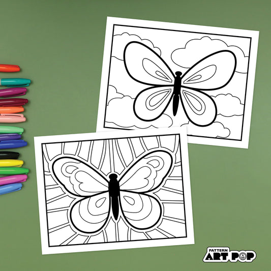 Two butterfly patterning pages with colored markers on a green background