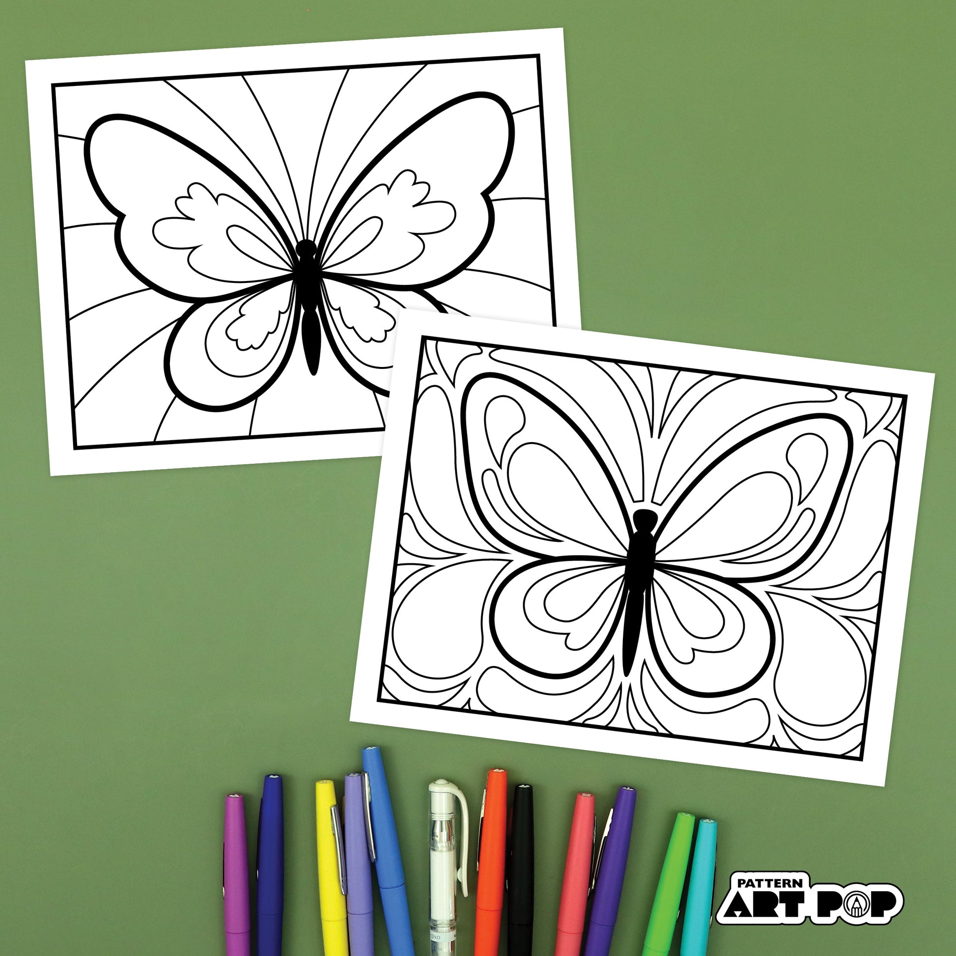Butterfly zentangle art pages with markers on a green background
